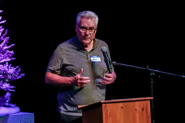 Speaker addressing the audience at the annual meeting