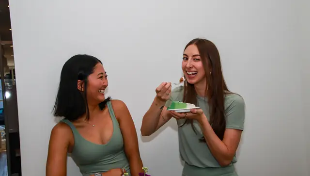 Guests sharing cake at the Bloom Loft celebration