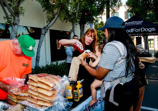 Hot dog vendor serving guests at the Community Howl