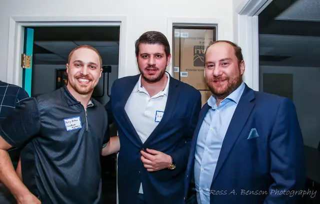 Three members smiling for a photo at the mixer