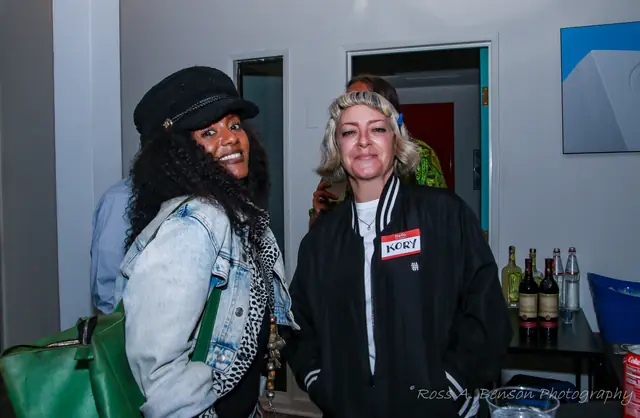 Two guests sharing a laugh near the bar