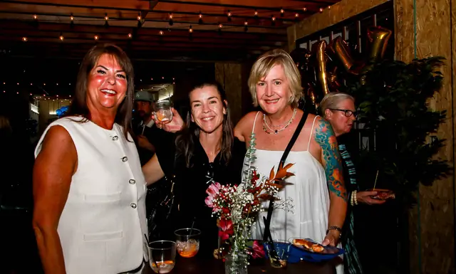 Guests enjoying drinks and appetizers at the mixer